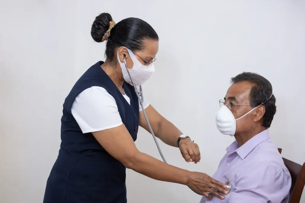 Nurse checking an elderly patient's vital signs during home healthcare