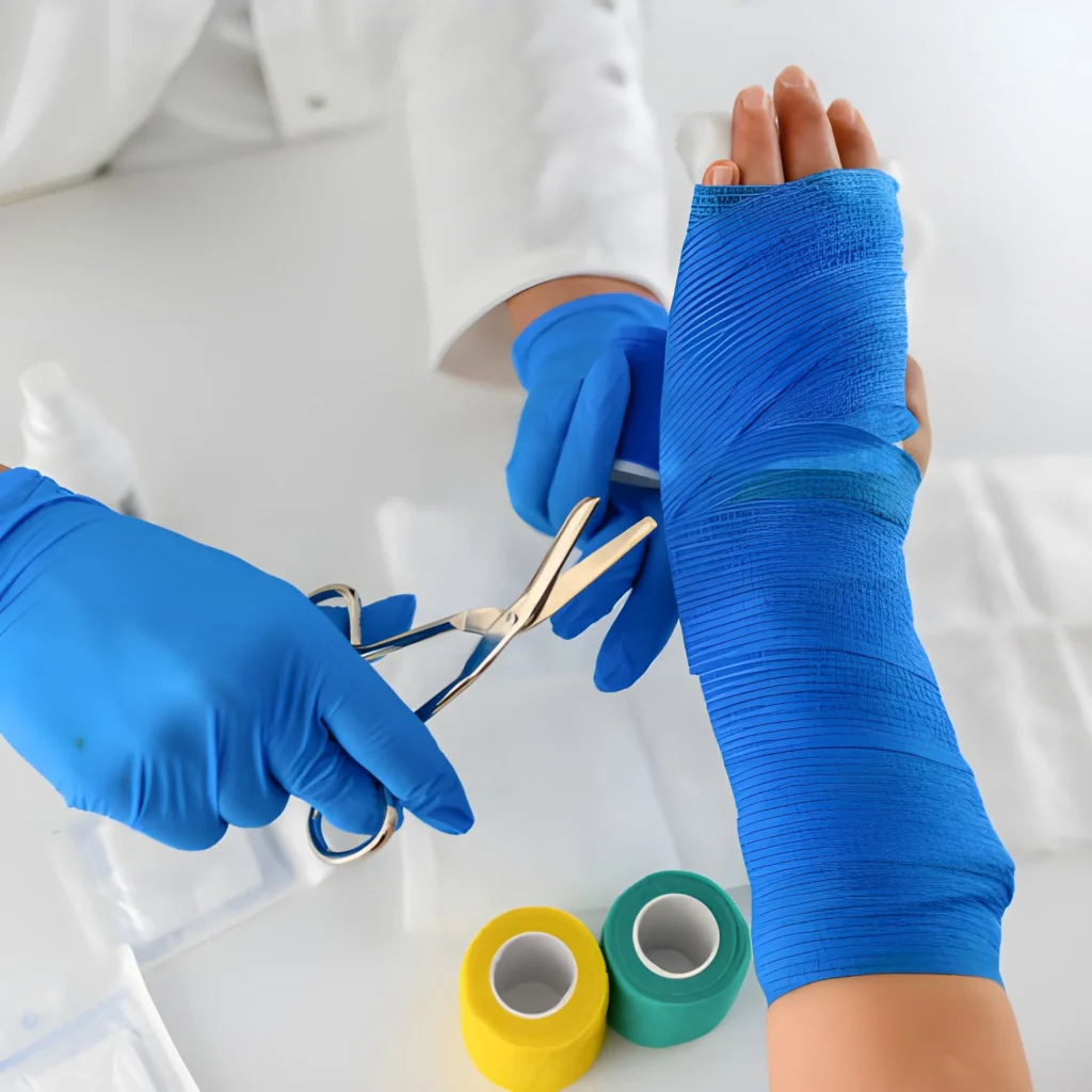 Healthcare professional applying a medical bandage to a patient's injured hand
